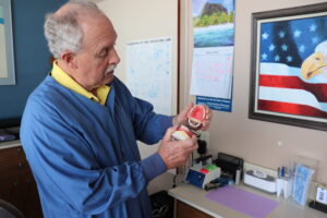 Dr. Hartman showing some dentures and how they articulate in his dental office