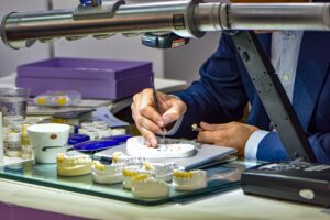 Dr Hartman working on dentures in the lab inside the dental practice in Bonner Springs, KS
